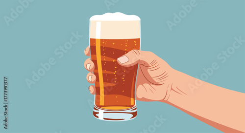 A person's hand firmly holds a tall, chilled glass of amber beer with a frothy white head and numerous bubbles, set against a clean blue background.