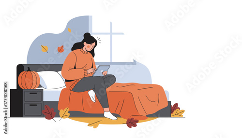 Sad woman uses a tablet in her cozy autumn bedroom struggling with depression or online stress