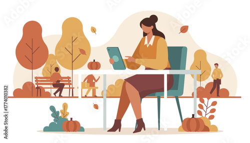 Professional woman uses a tablet at an outdoor table in a fall park Remote work concept