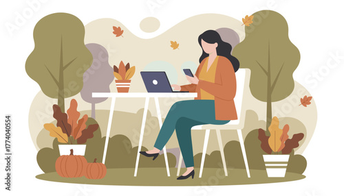 Freelance woman working remotely on laptop and phone in a cozy autumnal outdoor setting