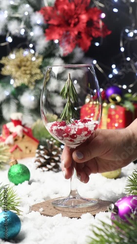 A Christmas Tree cocktail with rosemary, gin, and tonic, garnished with a Christmas cane Slow motion. close up. Festive Drink