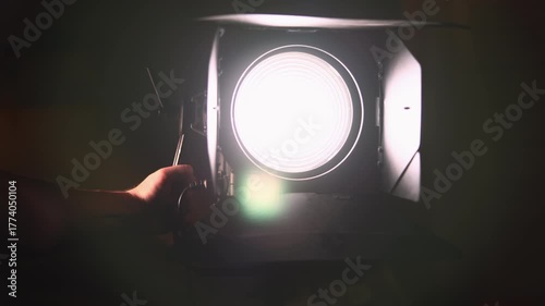 Professional studio fresnel spotlight turning on. Media