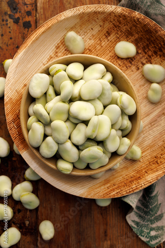 Fresh broad beans in a bowl, top view