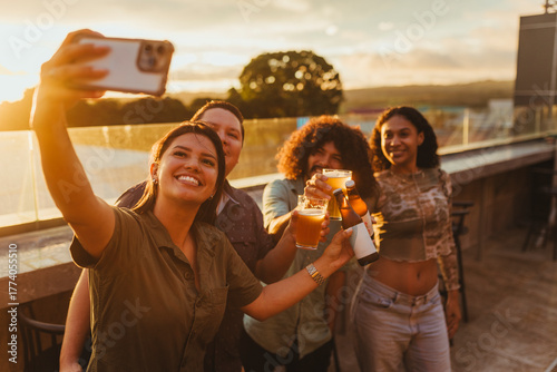 Sticker Happy friends making a toast and taking a selfie at sunset