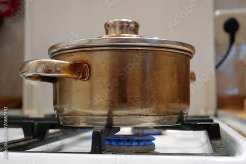 Saucepan is on the gas stove. Cooking. Meat is stewing