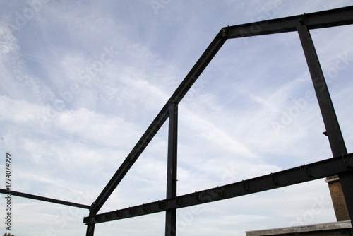 the steel construction of the side wall of a shed closeup in the countryside and the sky
