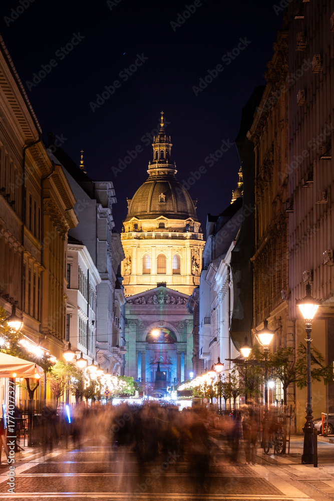 Fototapeta premium Christmas Advent fair with colorful lights in the square in front of the Saint Stephen's Basilica in Budapest