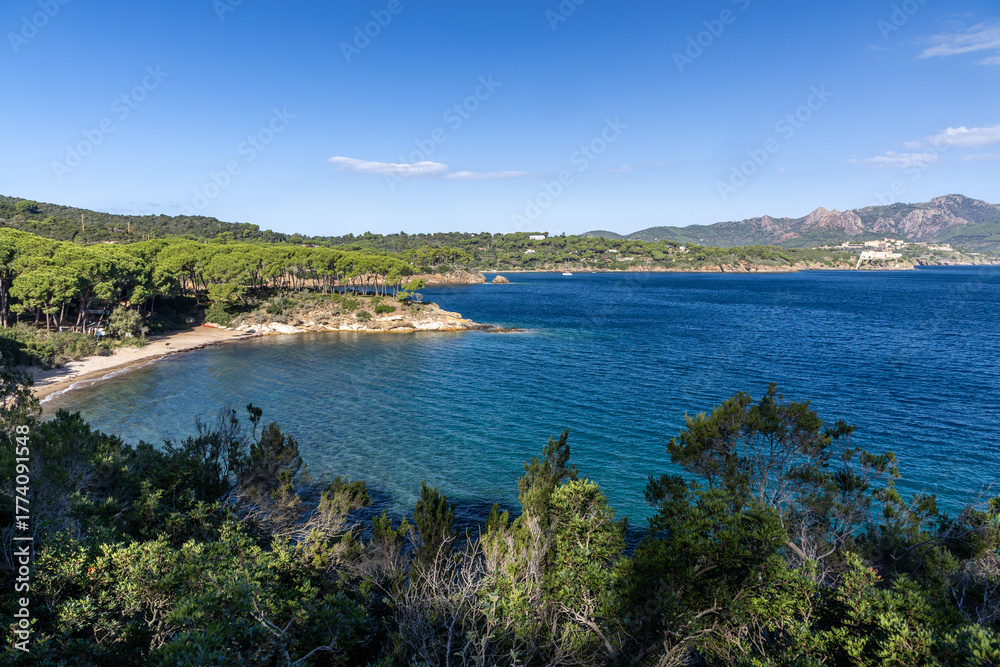 Fototapeta premium Elba Island Coastal View Over Dark Blue Sea - Scenic Seaside Landscape, Rugged Cliffs, Mediterranean Colors, Sunset Mood