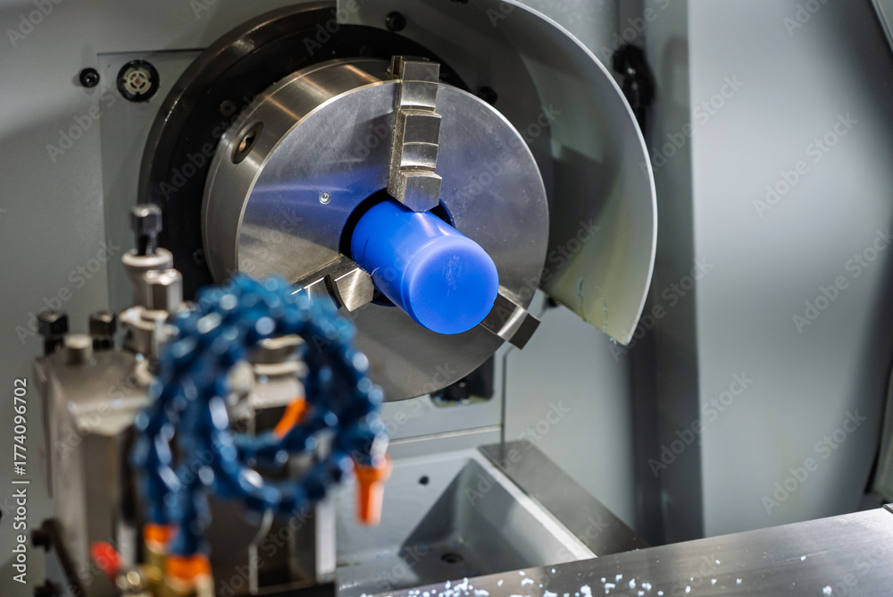Fototapeta premium Cnc machine. The CNC lathe machine or Turning machine. Turning numerical control machine with tools and chuck. Inside view of a cnc machine. CNC lathe interior