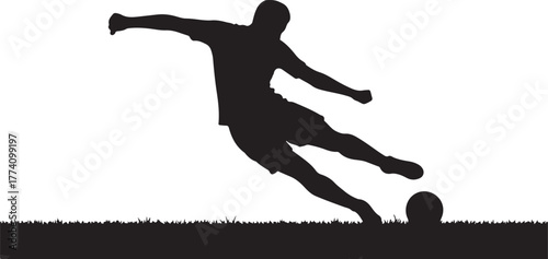 Black silhouette of a soccer player kicking a ball on grass