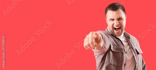Angry young man pointing at...