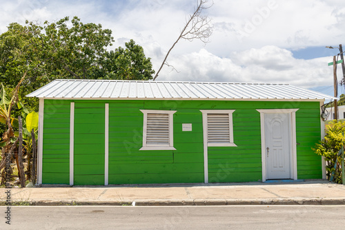 Pedernales, Dominican Republic, 8 august 2025. Typical Dominican Caribbean house made of wood, painted a bright green color.