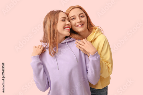 Mature woman hugging her yo...