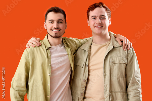 Male friends hugging on ora...