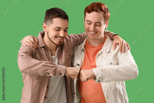 Male friends bumping fists ...
