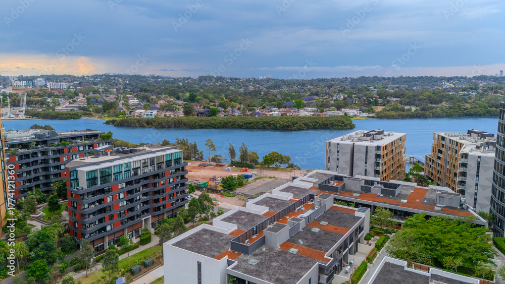 Obraz premium Aerial Drone View of Wentworth Point and Rhodes a suburb in western Sydney newly built residential high rise apartments area on Parramatta River Sydney NSW Australia