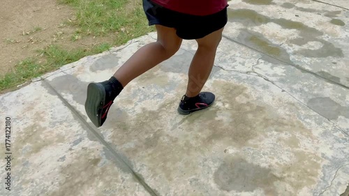 Fit male jogger running on road