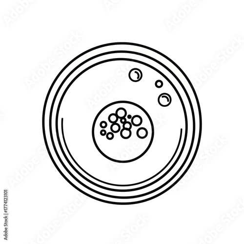 Petri dish containing cell culture being observed in laboratory setting, representing scientific research and experimentation in a sterile environment.