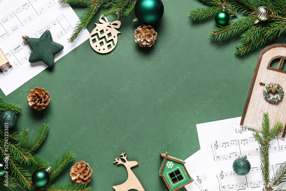 Naklejka premium Frame made of music sheets, fir branches and Christmas decorations on green background