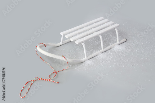 White wooden sled with red ...