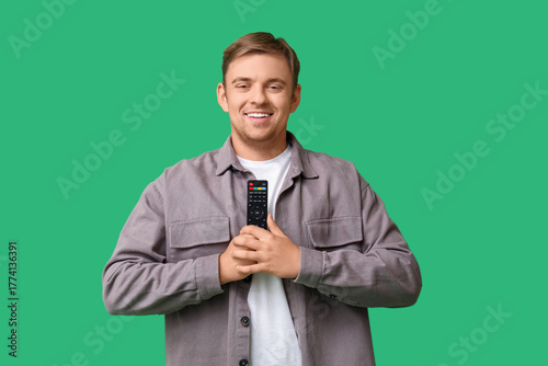 Young man with TV remote co...