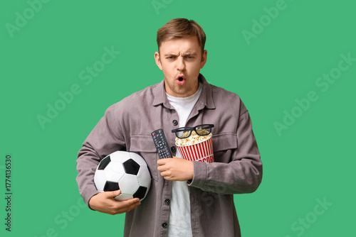 Young man with TV remote co...