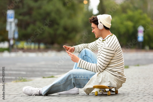 Happy young man in headphon...