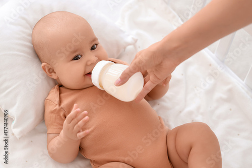 Happy baby drinking milk fr...