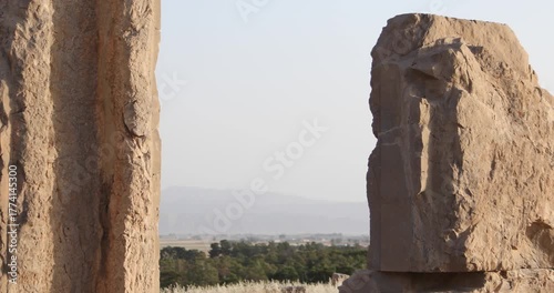 Warm light grazes a Persepolis doorway where a carved Achaemenid figure stands on a stone pillar. Weathered textures, open frame, and desert calm evoke endurance, memory, and timeless ritual.