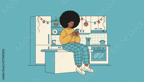 Young Black woman texting on smartphone in a modern kitchen decorated with holiday lights