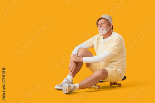 Senior man sitting on skate...