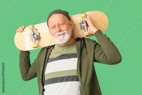 Senior man with skateboard ...