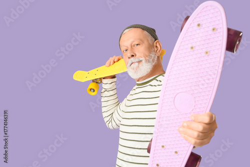 Senior man with skateboard ...