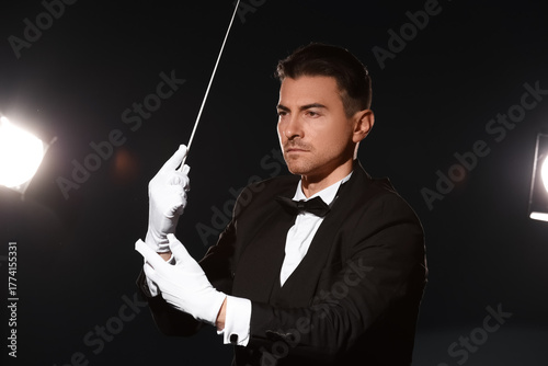 Young male conductor on dar...