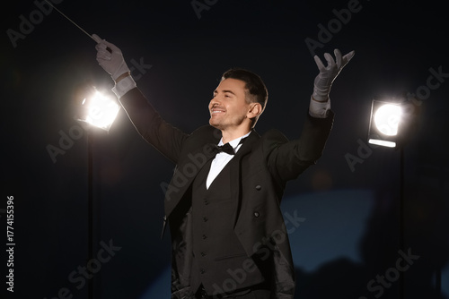 Young male conductor on dar...