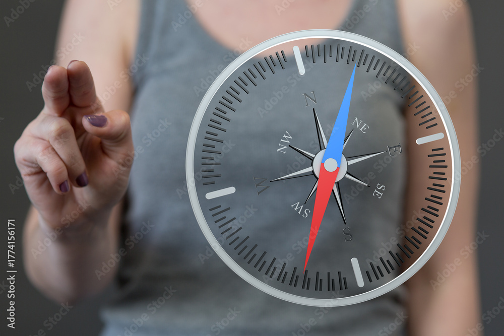 Fototapeta premium A person uses a compass to guide and point the direction, symbolizing strategy, navigation, and exploration.