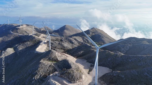 Aerial clip of a mountain top wind farm in morning light.
