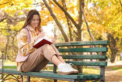 Happy young woman with book...