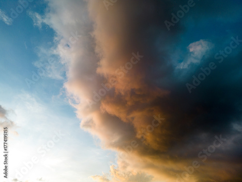 An aerial hyper lapse of colorful clouds at blue hour. Saturated colors and sun rays filtering through the cloud cover add to the beauty of the photo.