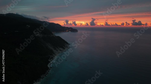 A blue hour aerial clip of the coastline towards Agios Nikitas village, Lefkada island, Greece.