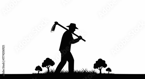 Silhouette of a farmer walking with a hoe over his shoulder.