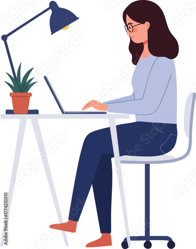 Businesswoman sitting at a desk with laptop and lamp, working