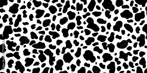 Seamless textured cow pattern. Vector long abstract background with repeating black hand-drawn spots on a white background. Vector monochrome texture.