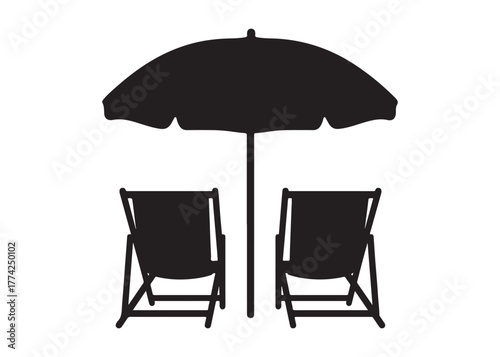 Silhouette of two beach chairs and umbrella