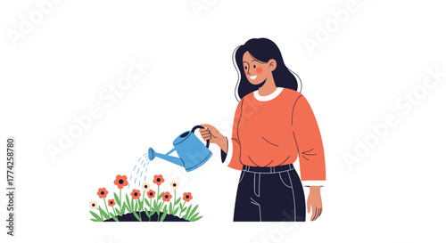 A happy young woman with dark hair waters a patch of red and white flowers with a blue watering can, tending to her garden.