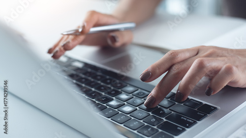 Close up, woman hand typing on laptop computer keyboard. Business woman online working on laptop computer, surfing the internet, searching the information at home office, e-learning