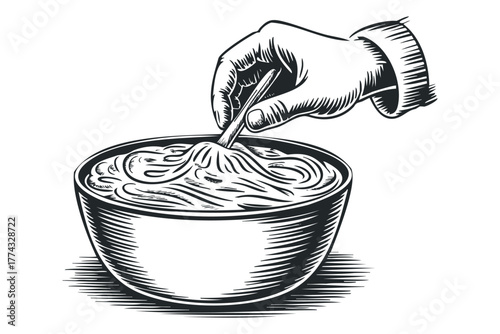 Hand holding chopsticks stirs bowl of noodles