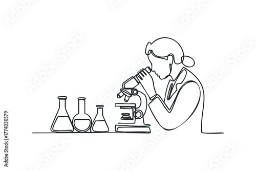 Scientist observes through microscope with laboratory flasks