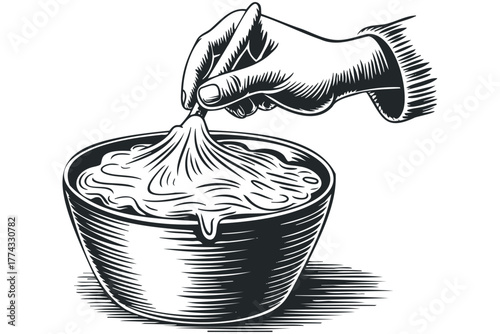 Hand dipping into a bowl of creamy food