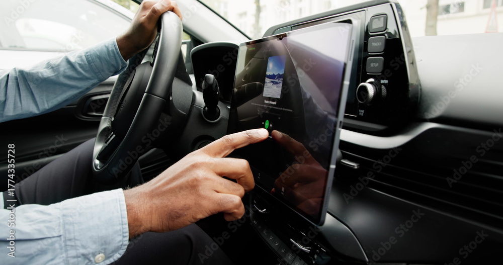 Naklejka premium Black Man Using Touchscreen Infotainment Panel